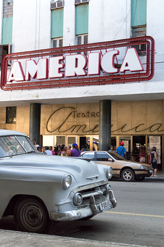 Havana, Сuba - June 11, 2014: Classic car parked in front of the famous America theater in Centro Havana district