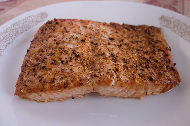 istock Broiled salmon with spices on white plate 536272463