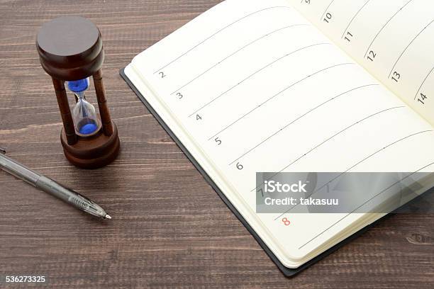 Hourglass And Personal Organizer Stock Photo - Download Image Now - 2015, Almanac - Publication, Arrival