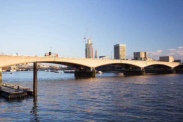 Waterloo Bridge in London, England London, England - December 28, 2014: A red double decker London bus with logos and adverts on it passes over Waterloo Bridge in London waterloo bridge stock pictures, royalty-free photos & images