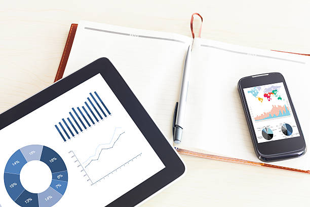 istock table with tablet,chart,and office supplies. 536274669