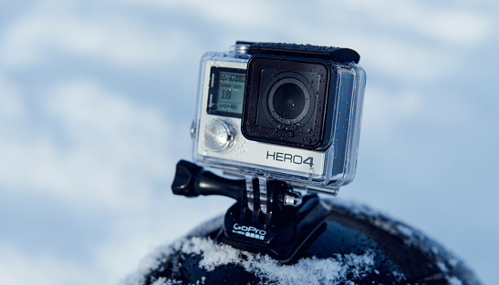 Taastrup, Denmark - December 29, 2014: GoPro Hero 4 Black Edition mounted on a skiing helmet outside in the snow. The action camera is capable of 4K recordings. 