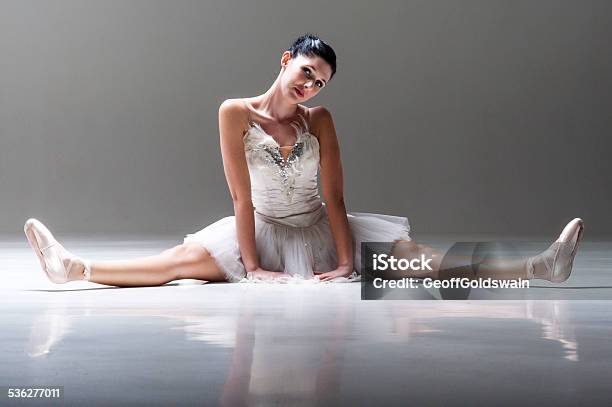 Young Attractive Ballerina Sitting On Floor Stretching Out Legs Stock Photo - Download Image Now