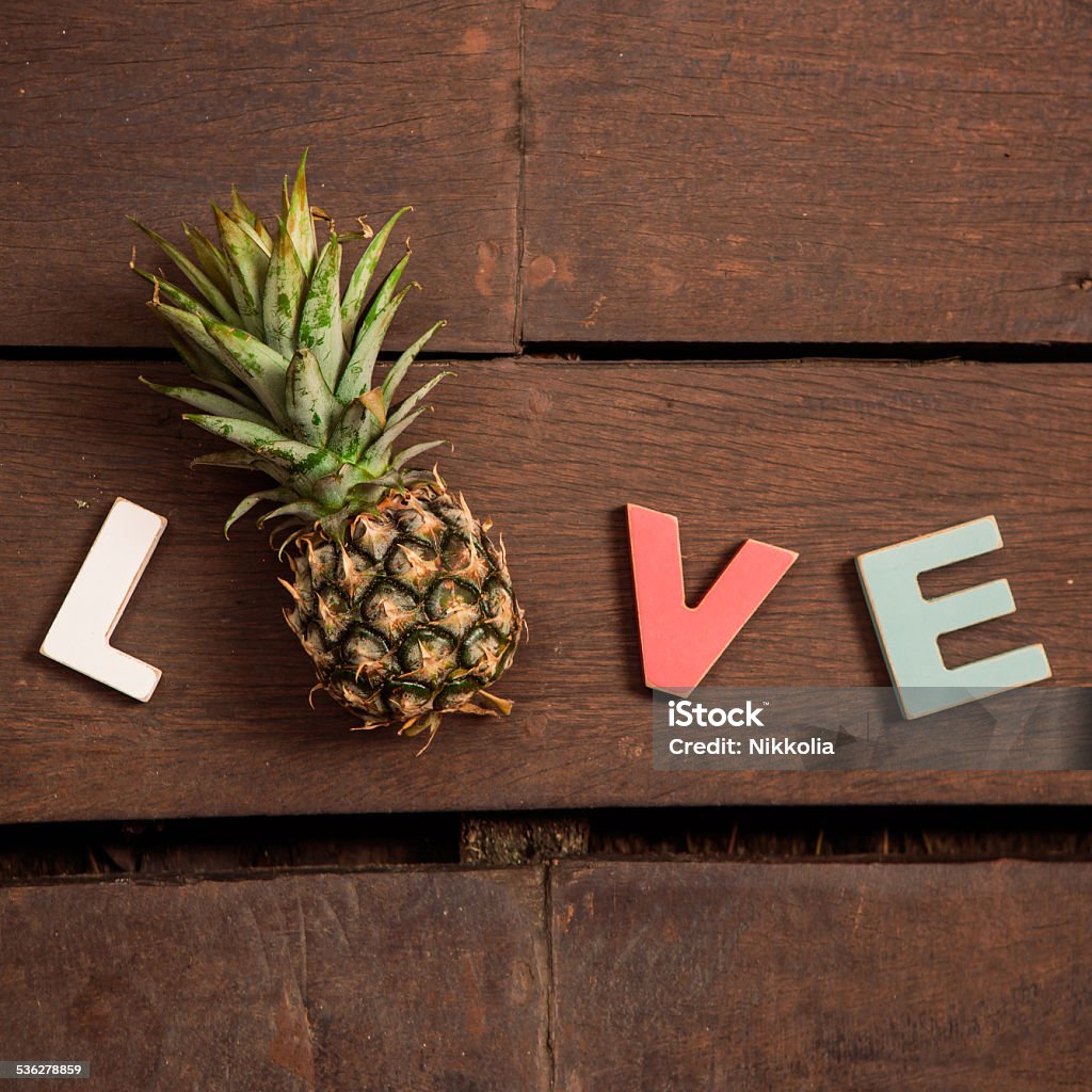 word love on the wooden floor word love made up of colorful wooden letters with ananas instead of letter O on the wooden floor. February 14, Valentine's Day 2015 Stock Photo