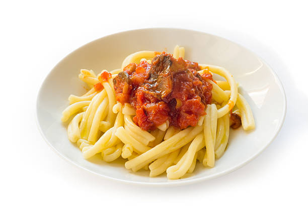 Pasta casereccia with mushrooms and tomato sauce stock photo