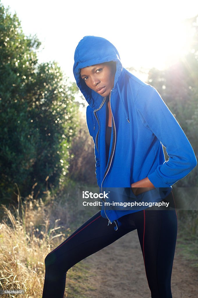 Fashion fitness model posing in blue sweatshirt outdoors Portrait of a fashion fitness model posing in blue sweatshirt outdoors 20-29 Years Stock Photo