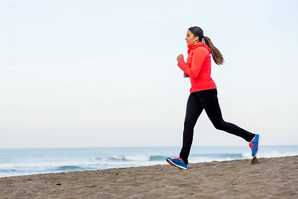 istock Serious Latino Woman Running on Beach 536289199