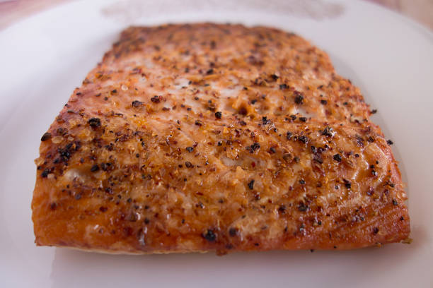 istock Broiled salmon with spices on white plate 536289591