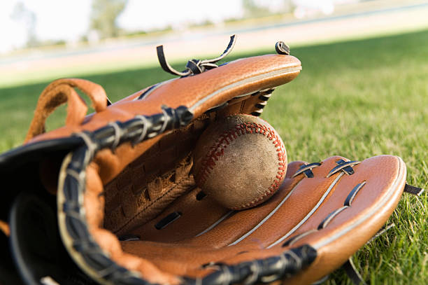 istock Baseball Glove and Ball Lying on Field 536292431