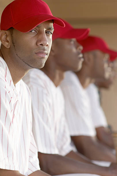 istock Baseball Player Sitting in Dugout with Team 536292503