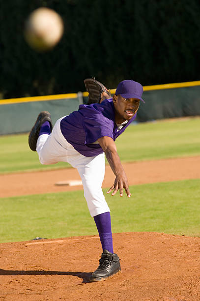 Pitcher Throwing Baseball Towards Batter Pitcher Throwing Baseball Towards Batter baseball pitcher baseball player baseball diamond stock pictures, royalty-free photos & images