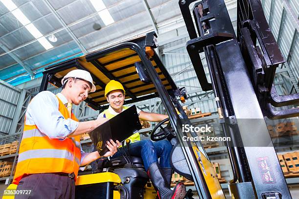 Asian Lift Truck Driver And Foreman In Storage Stock Photo - Download Image Now - Forklift, Driving, Driver - Occupation