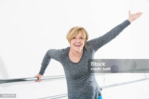 Woman Exercising In Dance Studio Stock Photo - Download Image Now - Mature Women, Arms Outstretched, Reaching