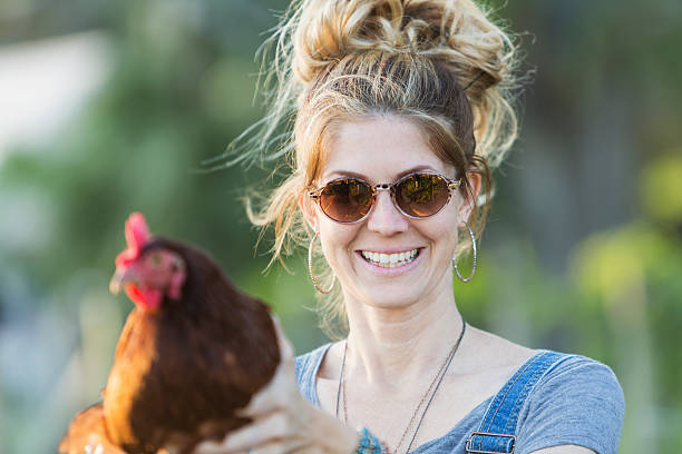 istock Woman holding rooster 536313841