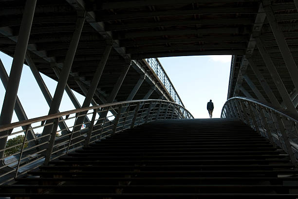 istock Solitary man walking through a tunnel into the light. 536314551