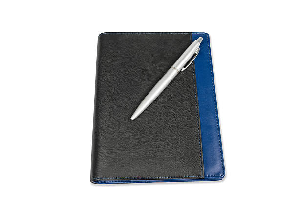 istock notebook calendar with silver pen isolated on white background 536352177