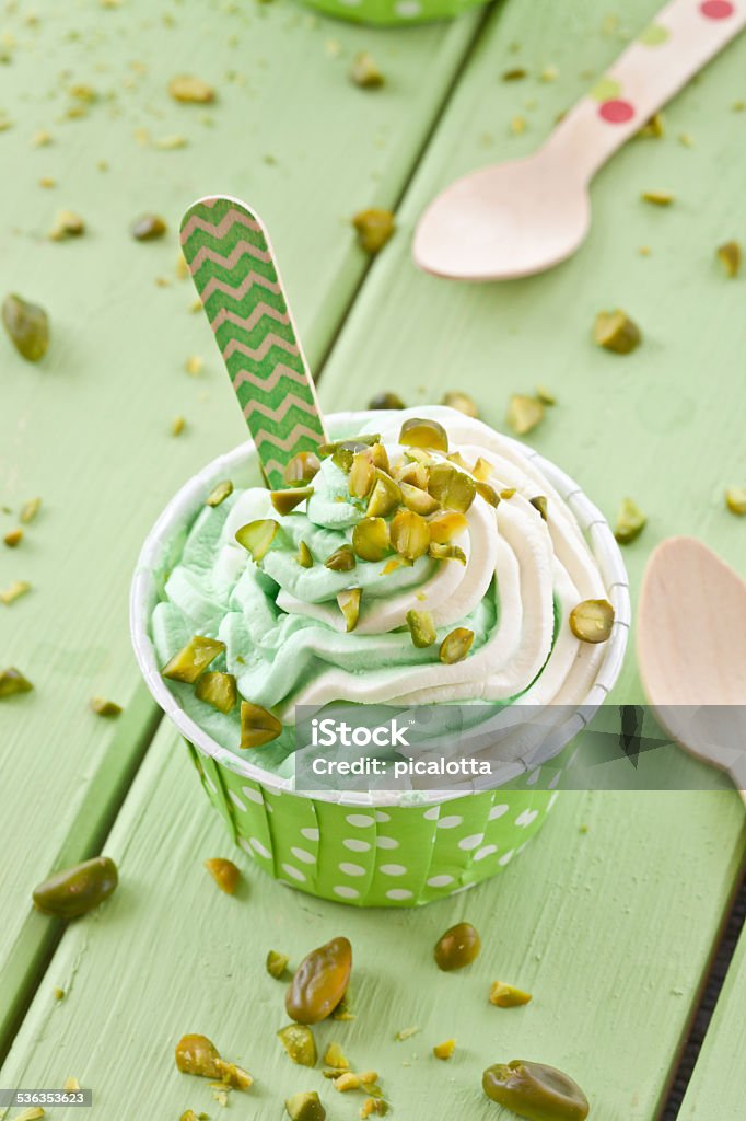 Frozen Yogurt with fresh pistachio Frozen yogurt with fresh pistachio in polka dot paper cup 2015 Stock Photo