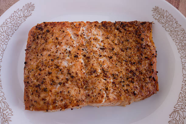 istock Broiled salmon with spices on white plate 536353839