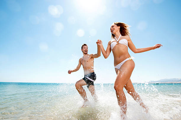 istock Happy couple running through sea. 536354669