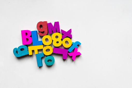 A shot of colorful alphabets and numbers over a white background.