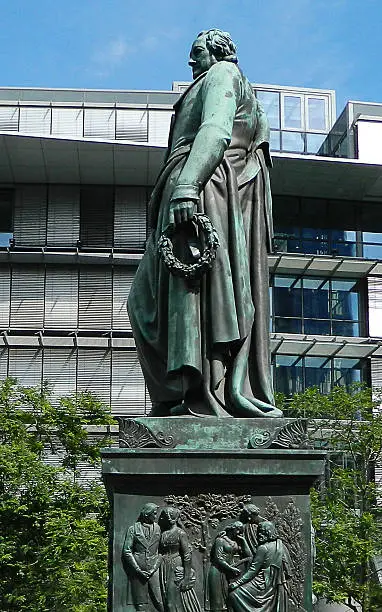 Statue of poet Johann Wolfgang von Goethe in Frankfurt, Germany. Sculptor Ludwig von Schwanthaler created the Goethe statue 1844 from bronze for the body and granite stone for the steps.