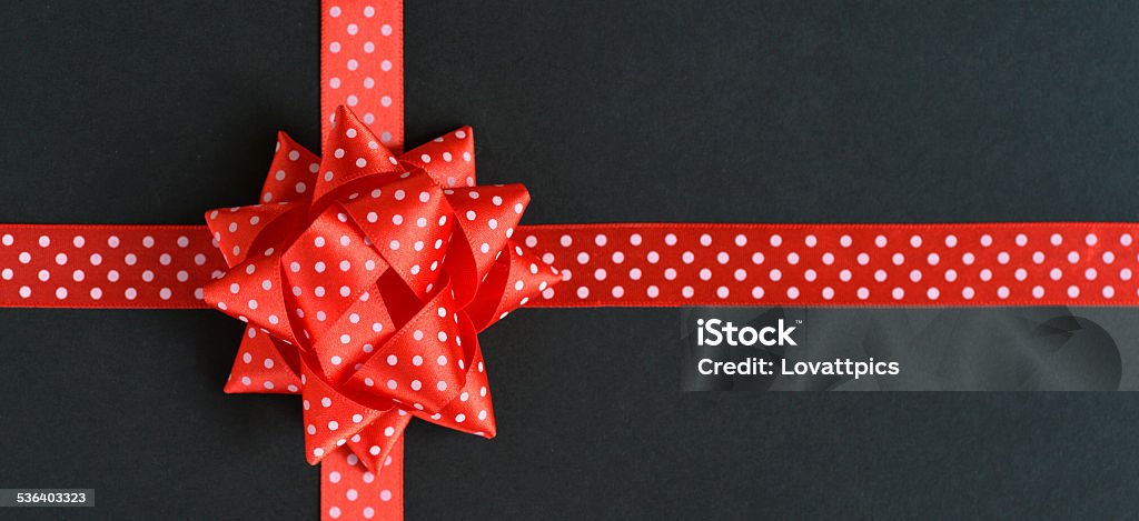 specialy wrapped gift. A special gift in a black box with red Ribbon and Bow with white spots. 2015 Stock Photo