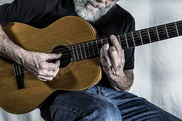 istock Senior Man Playing Acoustic Folk Guitar 536405359