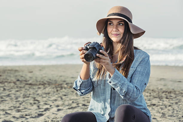 istock Young Attractive Latino Taking Picures on the Beach 536406169