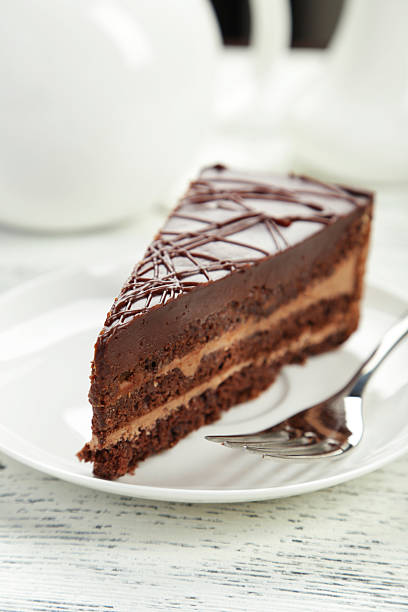 istock Dark chocolate cake on white wooden background 536406849