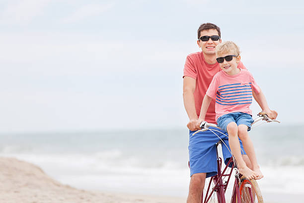 istock family biking at the beach 536407537