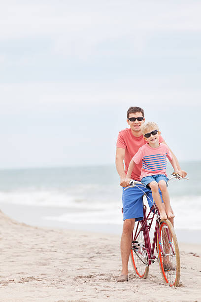 istock family biking at the beach 536407549