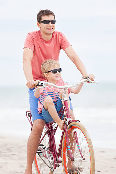 istock family biking at the beach 536407559