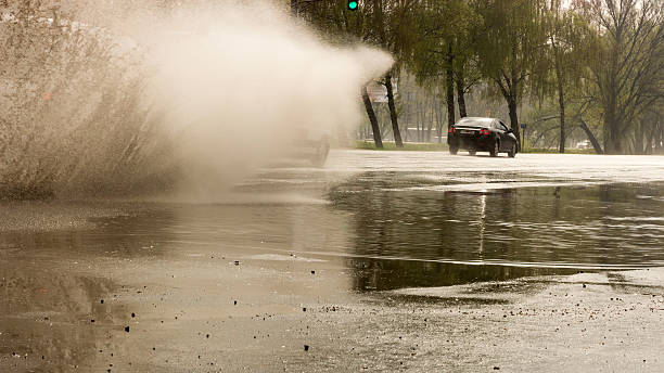istock splashes from under the wheels of a passing car through 536427930