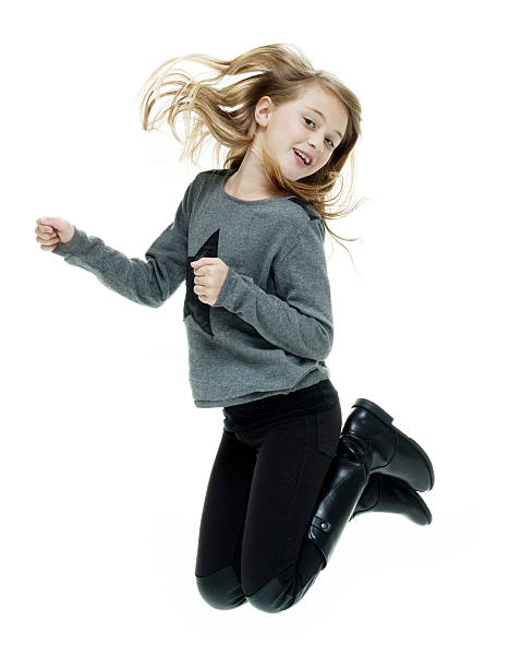 istock Smiling little girl jumping 536449500