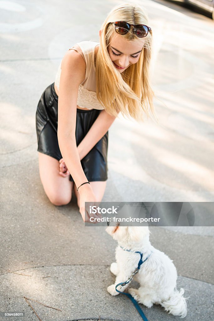 woman embracing her dog on the street Dog Stock Photo