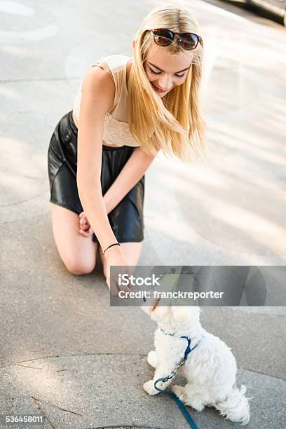 Woman Embracing Her Dog On The Street Stock Photo - Download Image Now - Dog, Petting, Sidewalk