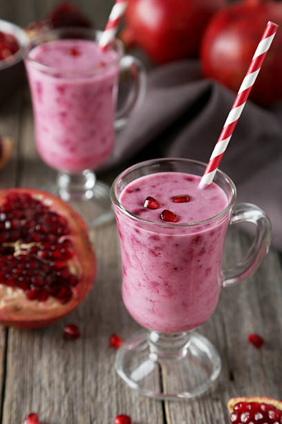 istock Pomegranate smoothie in glass on grey wooden background 536461501