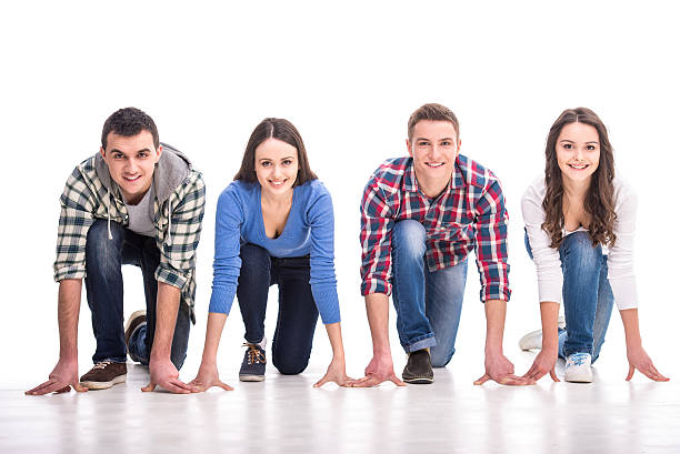 Students. People on starting line. Group of young people are standing on starting line and are looking forward while isolated on white. starting block stock pictures, royalty-free photos & images