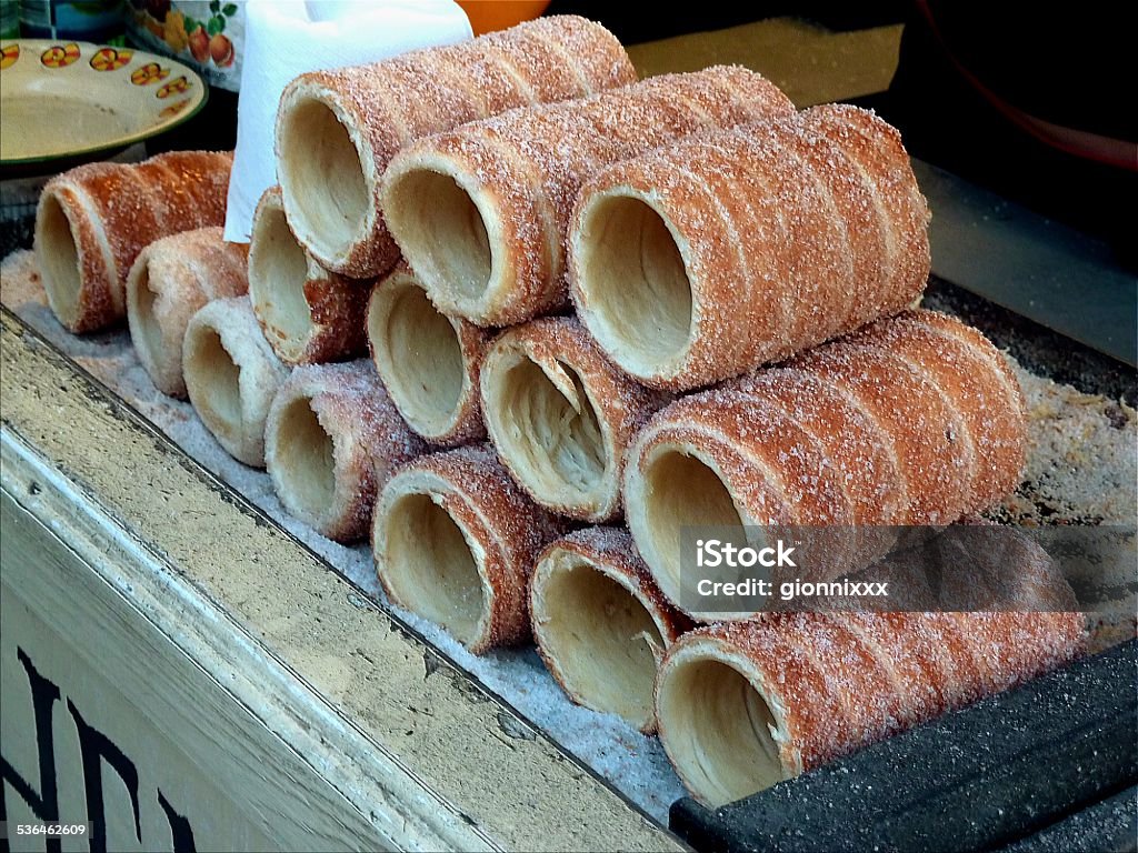 Trdelník, Prague Traditional Trdelník, a Hungarian cake and sweet pastry, originally coming from Transylvania. It also is known within the culinary heritages of Slovakia, the Czech Republic and Austria. It is made from rolled dough that is wrapped around a stick, then grilled and topped with sugar and walnut mix.  2015 Stock Photo
