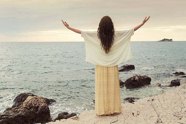 istock Girl open arms under on beach 536504257