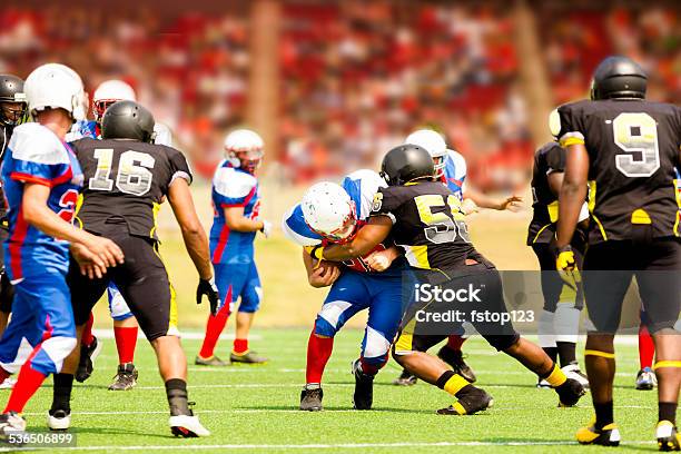 Football Teams Running Back Carries Ball Defenders Stadium Fans Field Stock Photo - Download Image Now