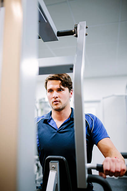 istock Determination using a resistance weight machine in the gym 536507361