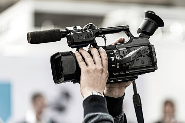 istock Cameraman holding tv camera high above 536507509