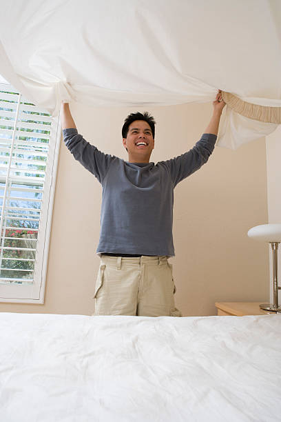 istock Mid-adult man making a bed 536508281