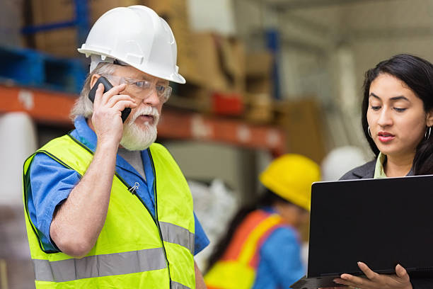 istock Senior warehouse worker talking on phone during meeting with supervisor 536509183