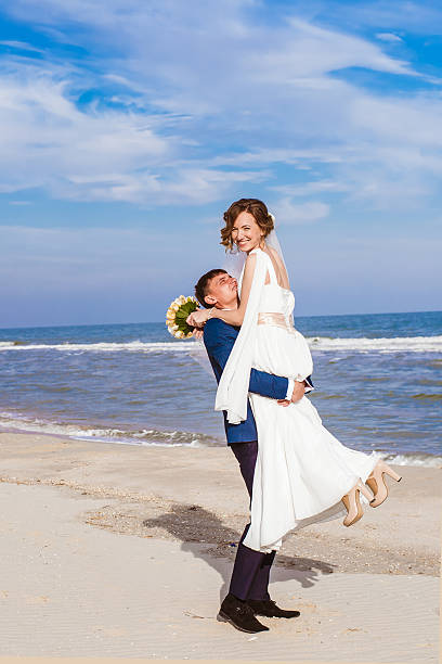 istock Young bride and groom on the beach 536552443