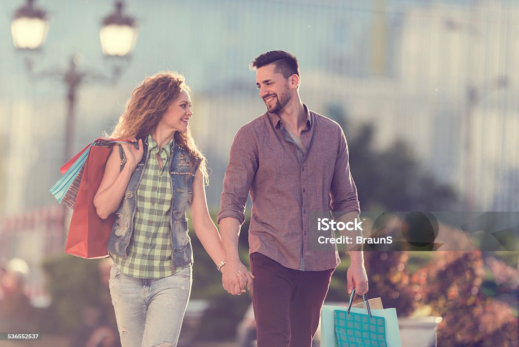 Young couple in shopping. Happy young couple shopping in the city and looking at each other. 2015 Stock Photo
