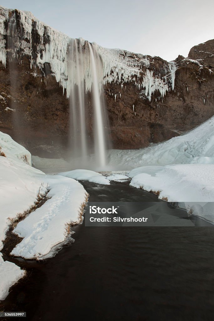 Seljalandfoss Waterfall covered in ice during winter. 2015 Stock Photo