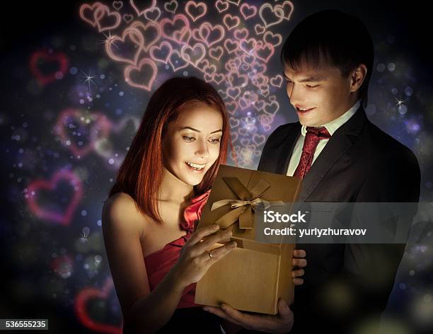 Happy Man Giving Gift To His Beloved Stock Photo - Download Image Now - 2015, Adulation, Adult