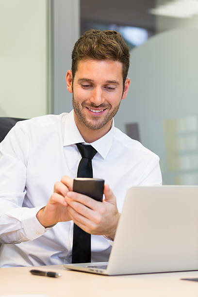 istock Businessman typing a message on mobile phone in office 536555825
